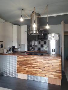 a kitchen with a wooden counter top in a room at Cosy & Charming logement moderne proche Paris in Arcueil