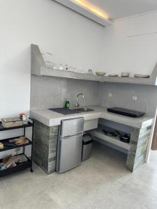 a kitchen with a sink and a counter at Michalelis cave & loft in Plomarion