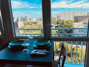 a table with a view of a city from a window at E&Y - Gare SNCF - Cité Congrès - Centre - Parking in Nantes