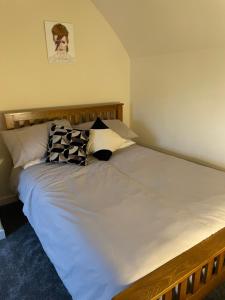 a bedroom with a large white bed with pillows at Oldshorecroft in Sheigra