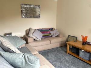 a living room with a couch and a table at Oldshorecroft in Sheigra