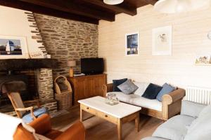a living room with a couch and a fireplace at cancaleloca in Cancale