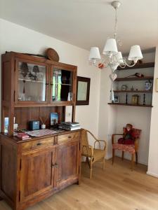 a room with a wooden cabinet and a chair at Casa delle Orchidee in Feltre +24 photos
