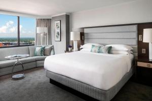 a hotel room with a large bed and a couch at The Ritz-Carlton Atlanta in Atlanta
