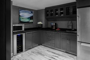 a kitchen with gray cabinets and a microwave and a refrigerator at The Ritz-Carlton Atlanta in Atlanta