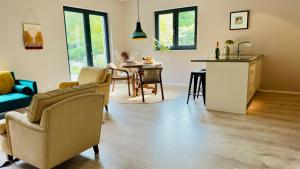 a kitchen and living room with a table and chairs at Het Nonnennest in Vught +11 photos