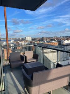 a balcony with chairs and a view of a city at Marina Bay in Aalborg