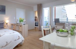 a bedroom with a bed and a table with a bowl of fruit at Ferienwohnung im Herzen vom Sylt in Westerland (Sylt)