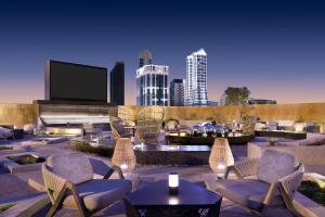 a patio with chairs and a tv in a city at JW Marriott Hotel Riyadh in Riyadh
