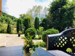 a bench sitting in the middle of a garden at Casa Sofia in Călimăneşti