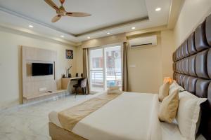a bedroom with a large bed and a television at The Lodgers Studio Sector 51 in Gurgaon