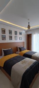 Giường trong phòng chung tại APPART-HOTEL La MAISON ATTAWBA 3 +21 ảnh