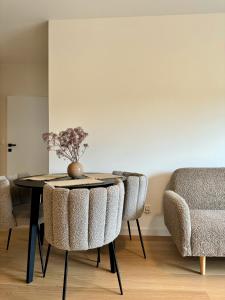 a dining room with a table and two chairs at Apartament Premium No 5 - Faktura VAT - Targi Kielce - Parking - Blisko Terenów Zielonych - NEW in Kielce