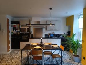 a kitchen with a table and chairs and a kitchen with at L'Escapade Manosquine - Parking Inclus in Manosque