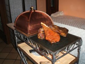 a grill with meat and vegetables on a table at Albergo Michieletto in Valmorea