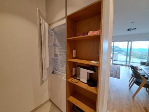 a room with a book shelf and a room with a window at Apartment Augenweide in Annenheim