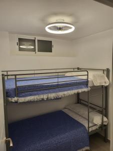 a room with two bunk beds and a light at Apartamento La Avenida in Lanjarón