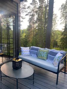 a couch on a screened porch with a table at Villa Falco in Espoo