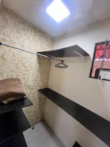 a room with black and white shelves and a wall at Pousada Três Corações in Penha