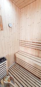 a sauna with a bed and a clock on the wall at Gîte château d'Espalungue, piscine et SPA in Dognen