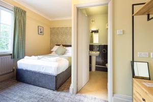 a hotel room with a bed and a bathroom at The Fox Inn in Guisborough