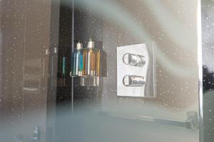 a shower with a glass door with a soap dispenser at The Fox Inn in Guisborough