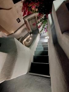a set of stairs with flowers on them at Aidos Villa Santorini in Megalokhori