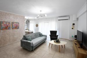 a living room with a couch and a table at Lux Mint Apartment - A modern Luxury place with Sea View in Epanomi