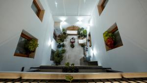an empty hallway with potted plants on the walls at Aparthotel Luz de Gades - Suites Spa Gym - Adults Only in Cádiz