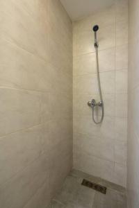 a bathroom with a shower with a shower head at Luxury One Bedroom Apt - Agdal 1 in Rabat
