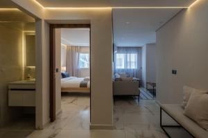 a room with a bed and a living room at Luxury One Bedroom Apt - Agdal 1 in Rabat