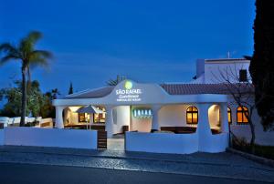 a white house with a sign on the front of it at Sao Rafael Holidays in Albufeira
