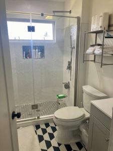 a bathroom with a toilet and a glass shower at 1940s Urban charmer modern upgrades in Auburn