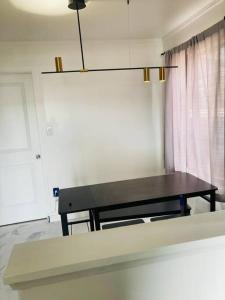 a black table in a room with a window at 1940s Urban charmer modern upgrades in Auburn