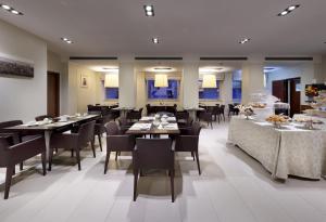 un gran comedor con mesas y sillas en Hotel Saint John, en Roma