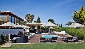 a resort with a pool and chairs and umbrellas at Sao Rafael Holidays in Albufeira