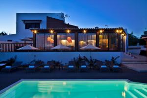 a villa with a swimming pool at night at Sao Rafael Holidays in Albufeira