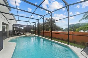 an indoor swimming pool with a glass roof at Magic Kingdom Villa - Private Master Bedrooms in Kissimmee