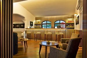 a bar in a restaurant with chairs and tables at Sao Rafael Holidays in Albufeira