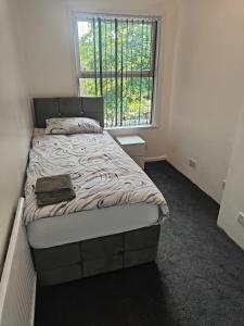 a bed in a room with a large window at Golden hour in Overstone