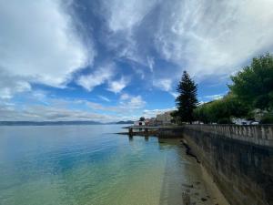 a view of a body of water with a pier at Lar dos Galos in Bueu