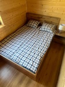 a bed in a sauna with two pillows at Domek Leon in Okuninka