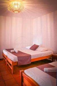 Postel nebo postele na pokoji v ubytování Aura Hotel Parque Barichara By Infinity