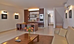 a living room with a couch and a table at Sao Rafael Holidays in Albufeira