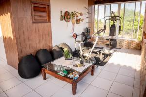 a living room with a couch and a table at Flats Villa Gelú in Barra Grande
