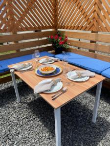 a wooden table with a plate of food on it at Villetta Solare in Belmar