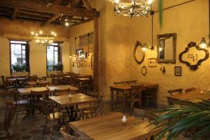 an empty restaurant with wooden tables and chairs at Valerio Hotel Boutique in Marinilla