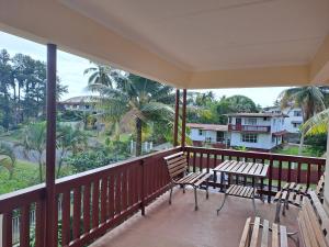 a balcony with chairs and a table with a view at Sekoula Home in Suva