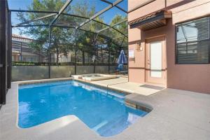 a swimming pool in the backyard of a house at Experience Solterra: Pool, Spa, Game Room & Lazy River in Davenport