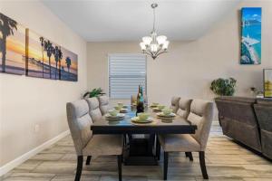 a dining room with a table and chairs at Experience Solterra: Pool, Spa, Game Room & Lazy River in Davenport